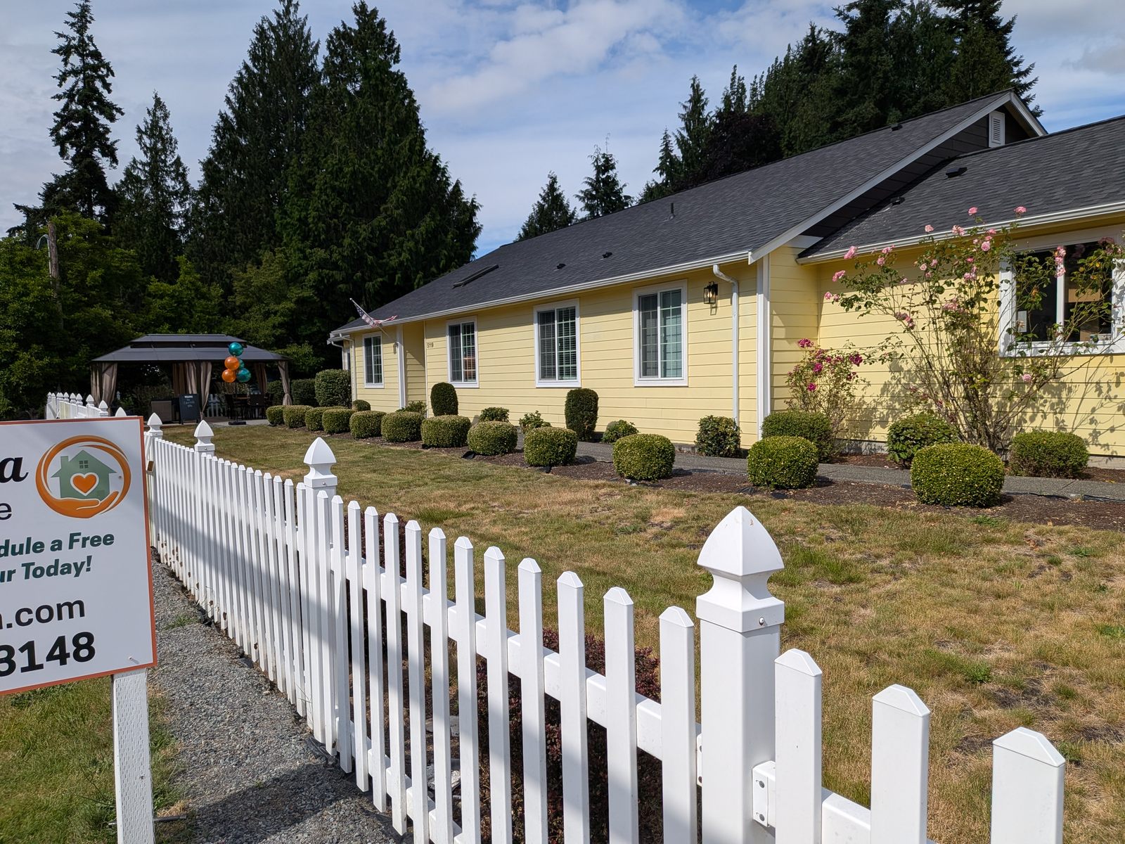Freshly painted yellow exterior of Edmonds Villa adult care home in residential neighborhood