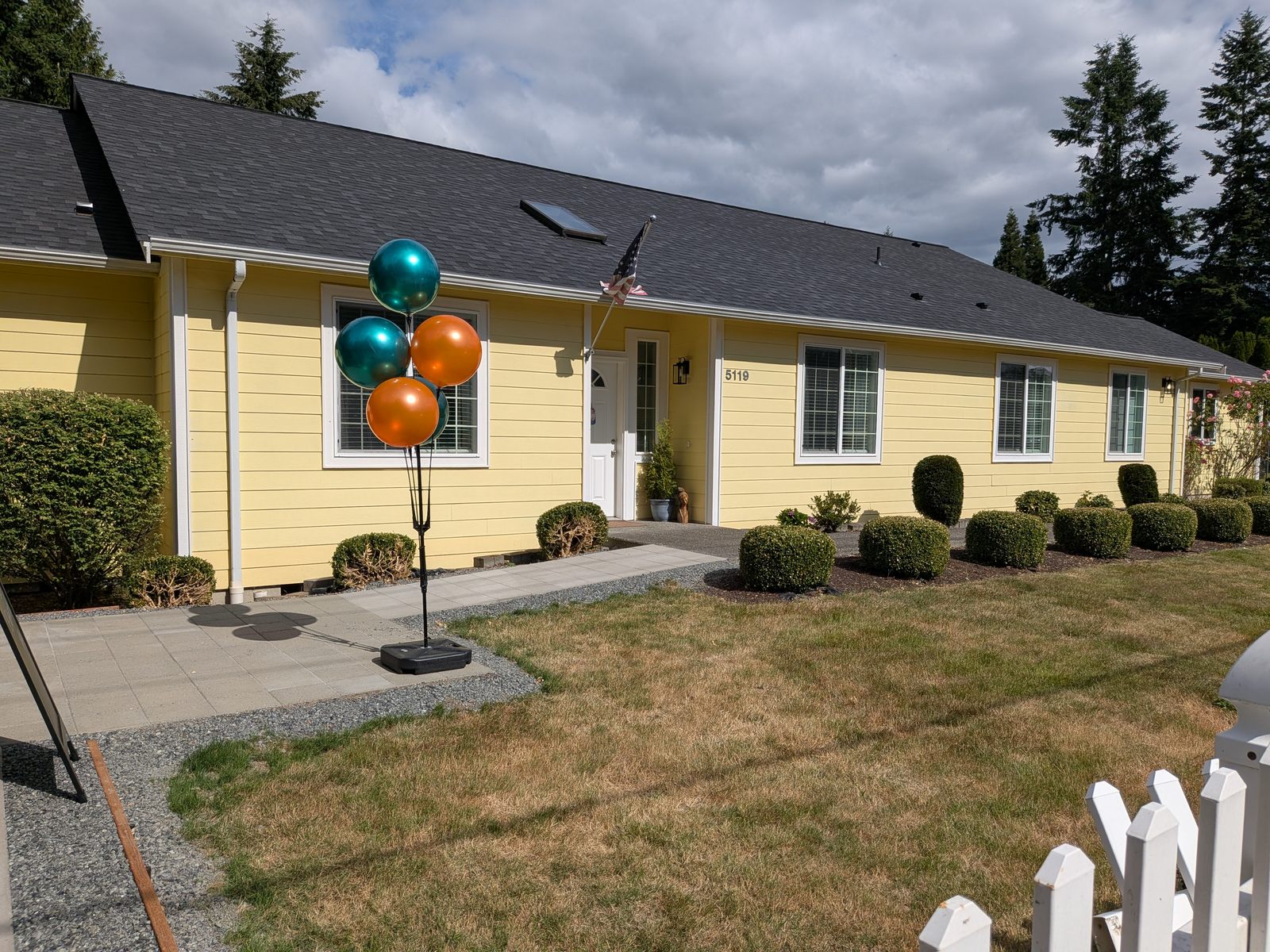 Beautifully landscaped front grounds with facility signage at Edmonds Villa AFH
