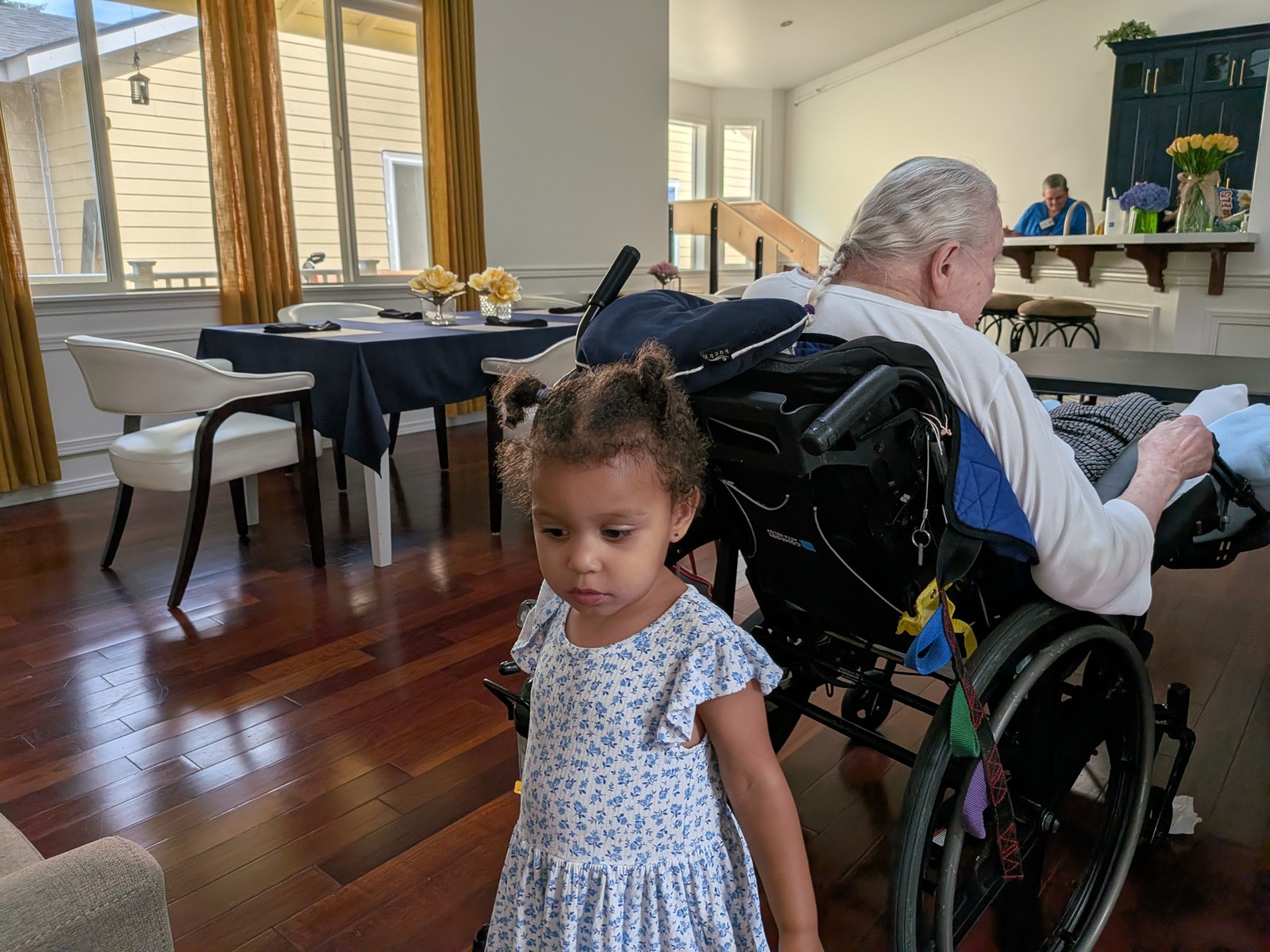 Child visiting senior resident at Edmonds Villa adult family home — family connections in home setting
