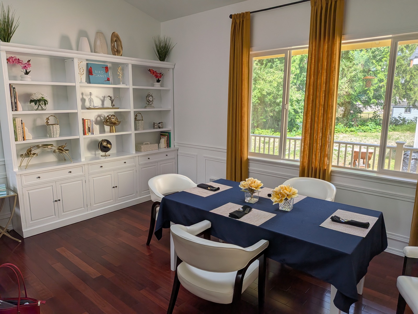 Bright dining room with bookshelf and window view at Edmonds Villa — home-cooked meals for residents