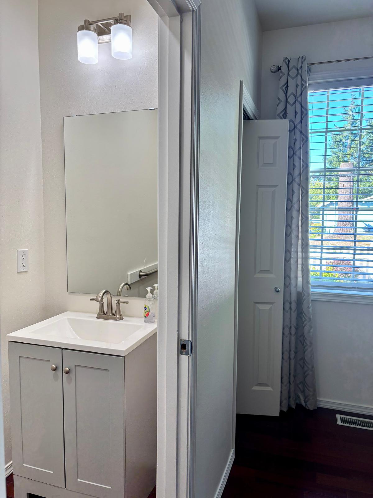 Ensuite bathroom with white vanity at Edmonds Villa — private bathroom for resident comfort