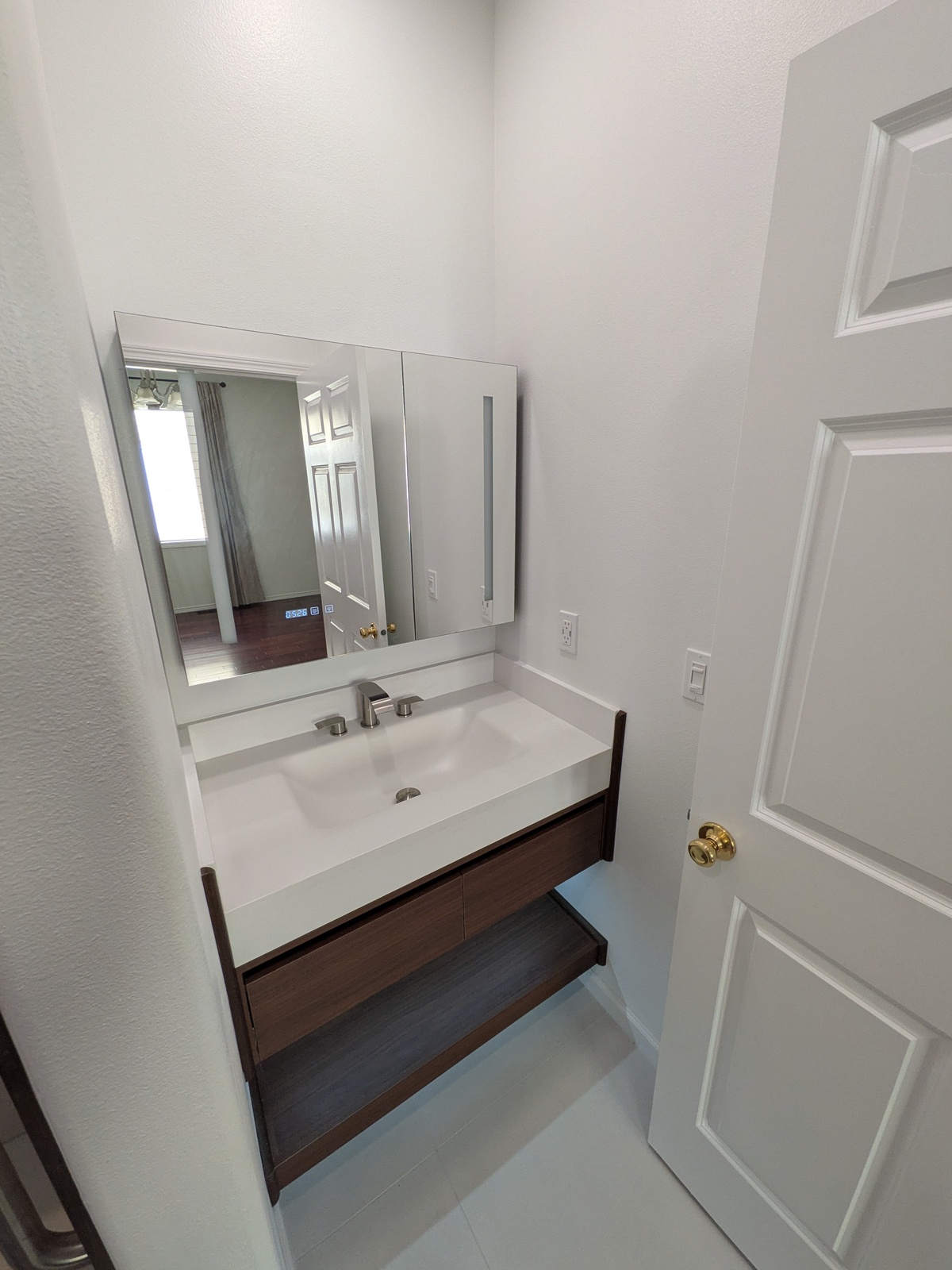 Modern bathroom vanity with accessible floating sink at Edmonds Villa adult care home
