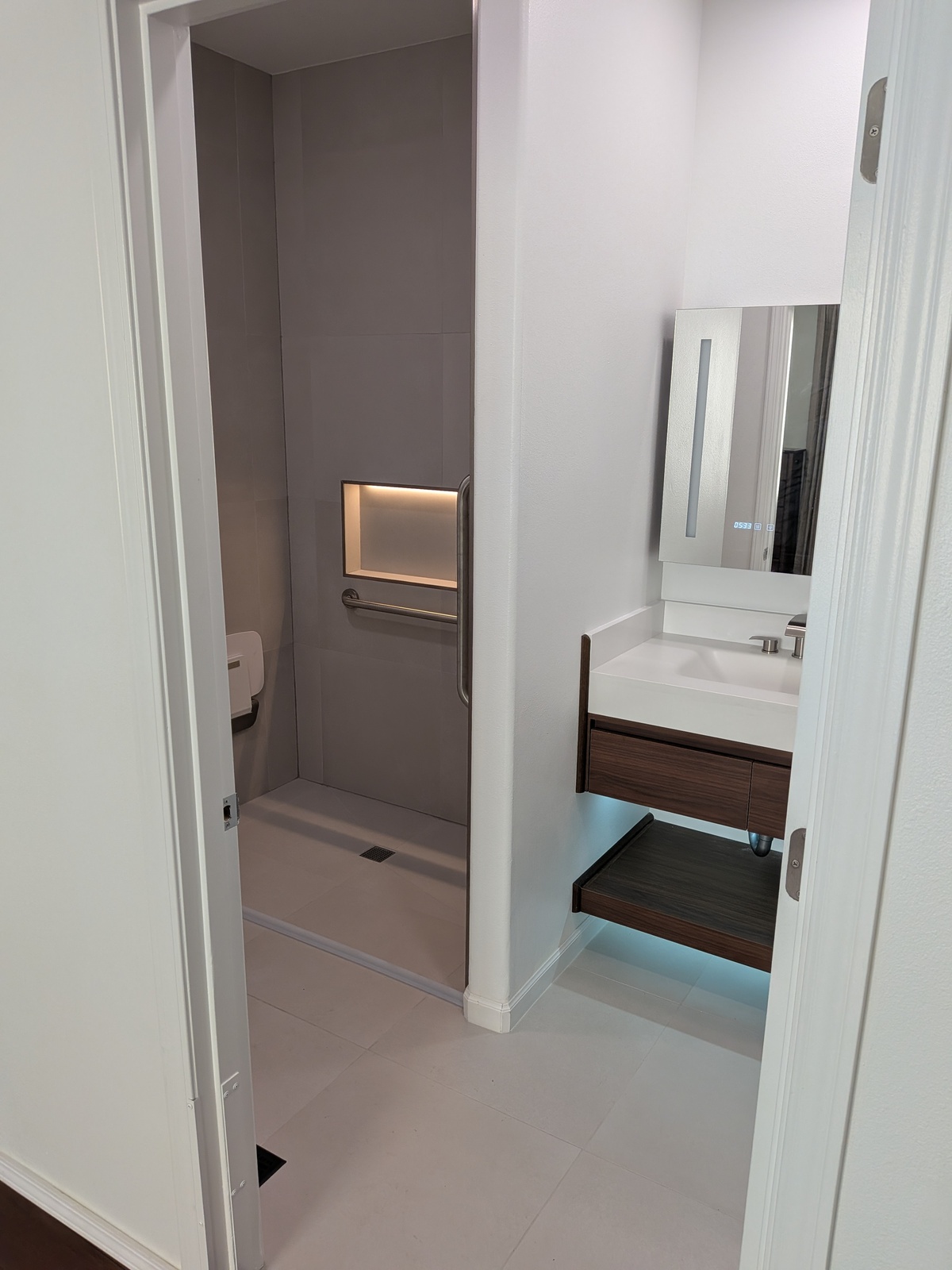 Modern walk-in shower with accessible grab bars at Edmonds Villa — renovated bathroom for seniors