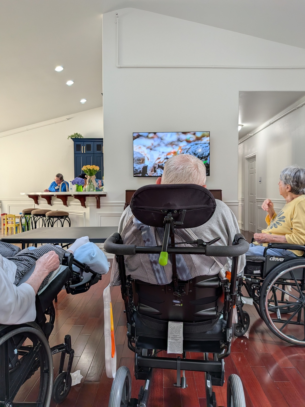Residents enjoying television in common area at Edmonds Villa adult family home
