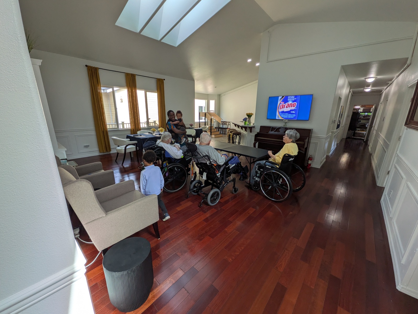 Spacious living room with vaulted ceiling at Edmonds Villa adult family home — comfortable common area for residents