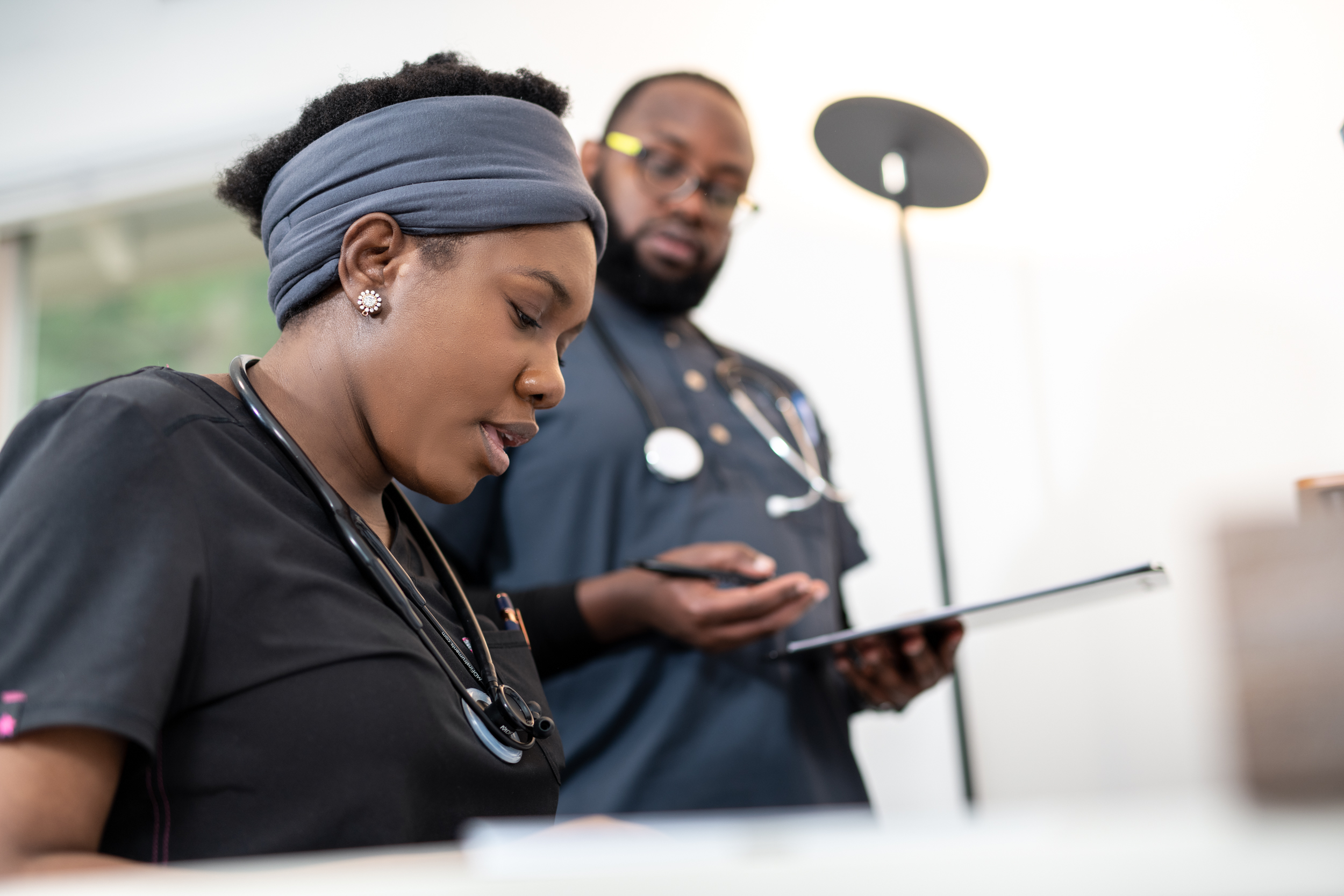 Healthcare team reviewing care plans on tablet