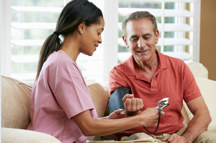 Nurse checking blood pressure for senior - clinical excellence in home setting